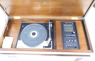 A mahogany cased Dynatron radiogram, with a Dynotron radio and stereophonic tuner amplifier SRX 29C, and a Garrard SP25 MKIV turntable, the box casing raised on square legs united by a H stretcher. - 3