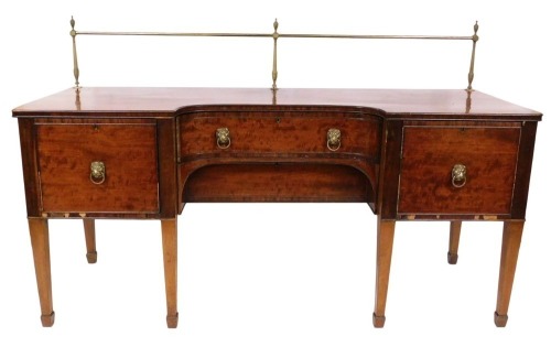 A George III mahogany inverted break front sideboard, with a brass galleried back, with two central drawers, flanked by a cupboard door and a cellarette drawer, raised on tapering square legs, on spade feet, 91cm high, 201.5cm wide, 71cm deep.