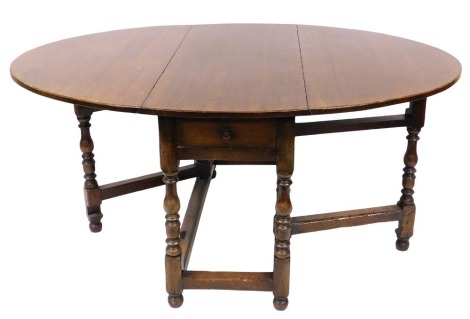 A Georgian style oak gate leg dining table, possibly Titchmarsh & Goodwin, raised on turned supports united by a box stretcher, 75cm high, 122cm wide, 51cm deep, 165.5cm extended.