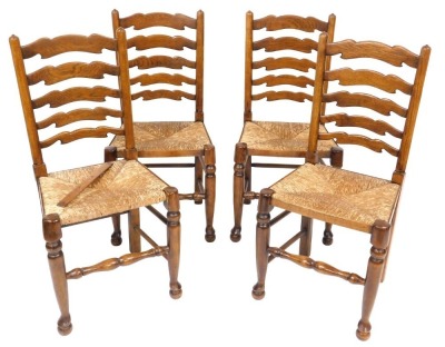 A set of four Titchmarsh & Goodwin oak rush seated ladder back single dining chairs.