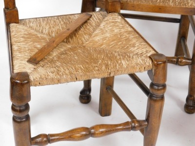 A set of four Titchmarsh & Goodwin oak rush seated ladder back single dining chairs. - 2