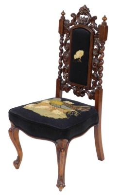 A Victorian mahogany side chair, with a woolwork seat and back, with carved decoration, raised on cabriole legs.