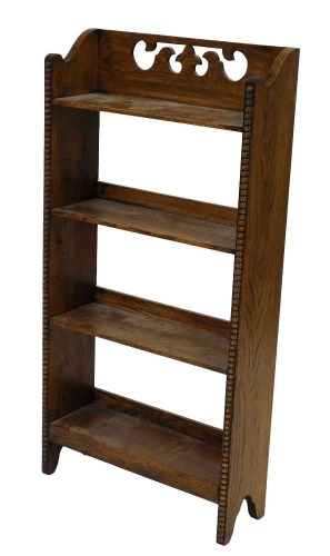 An early 20thC oak open bookcase, of four shelves, raised on beadwork fronted supports, 91cm high, 46cm wide.