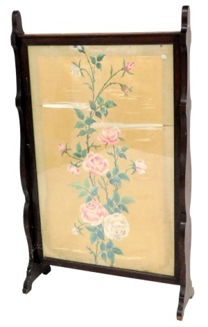 An Edwardian mahogany fire screen, with a rectangular silk banner, painted with flowers in a Chinese style, on end supports, 116cm high, 69cm wide.