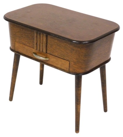 A mid century oak sewing box, with a hinged lid opening to reveal a lined interior, over a frieze drawer, raised on turned legs, 46.5cm high, 51cm wide, 32cm deep.