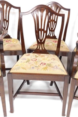 A set of six Hepplewhite style mahogany dining chairs with shield shaped backs, drop in floral tapestry seats, raised on tapering square legs united by a H frame stretcher, comprising a pair of carvers and four single chairs. - 3