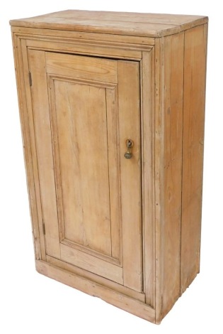 A 19thC pine kitchen cupboard, with a panelled door opening to reveal two shelves, raised on a plinth base, 117cm high, 67cm wide, 38cm deep.