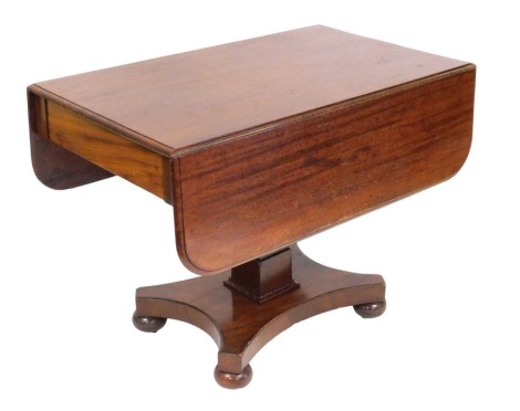 A Regency mahogany Pembroke table, raised on a square column over a quatrefoil base, on bun feet, 73cm high, 97cm wide, 57cm deep, 111cm extended.