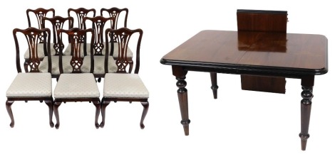 A Victorian mahogany and ebonised draw leaf dining table, with one additional leaf, raised on turned and reeded supports, 76cm high, 130cm wide, 181cm extended, 97cm deep, together with eight oak single dining chairs, with overstuffed seats, raised on cab