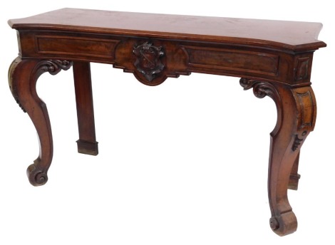 A Victorian mahogany serving table, with a curved top over a frieze with carved coat of arms above a pair of front foliate carved cabriole legs, 92cm high, 156cm wide, 57cm deep.