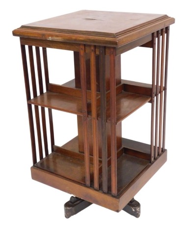 A Victorian mahogany revolving bookcase, of two tier, square section, each with four recesses, raised on a X frame base, on castors, 88.5cm high, 48.5cm wide, 48.5cm deep.