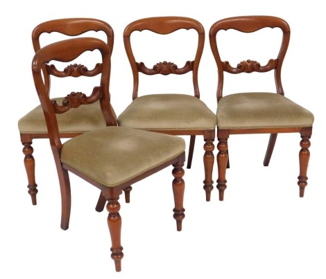 A set of four Victorian mahogany balloon back dining chairs, with green draylon overstuffed seats, raised on turned legs.