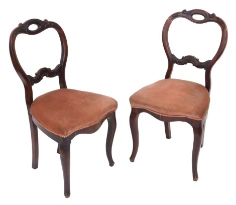 A pair of Victorian mahogany balloon back dining chairs, upholstered in pink draylon, raised on cabriole legs.