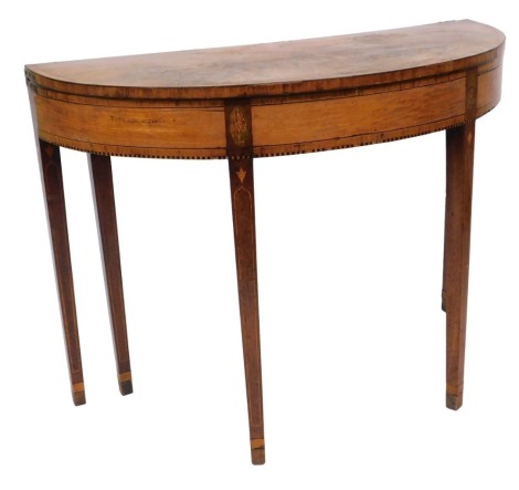 A George III mahogany and satinwood demi lune fold over card table, with rosewood cross banding and inlaid foliate decoration, raised on tapering square legs, 74cm high, 101cm wide, 43cm deep.