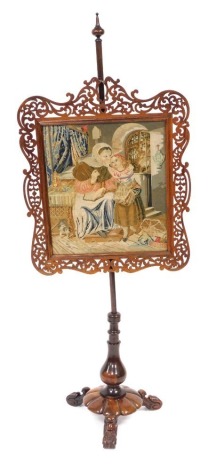 A Victorian rosewood pole screen, the rectangular screen with fret work foliate carving, decorated centrally with a wool work tapestry of a pastoral interior, raised on a turned column over a fluted circular base and three leaf carved scroll feet, 170cm h