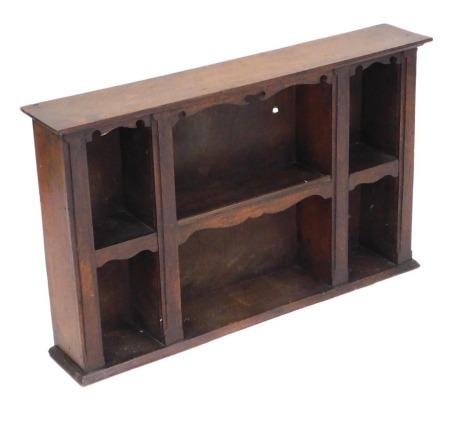 A late Victorian oak wall hanging kitchen shelf, of six compartments, 49.5cm high, 78.5cm wide, 14cm deep.