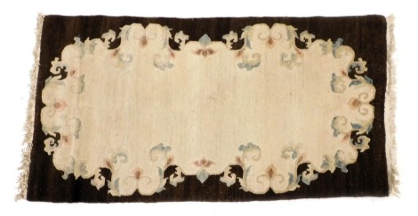 A Chinese cream and brown ground floral rug, 88cm x 177cm.