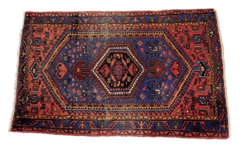 A Persian blue ground rug, decorated with a central medallion, within a field of birds and flowers, within repeating floral and foliate borders, 211cm x 129cm.