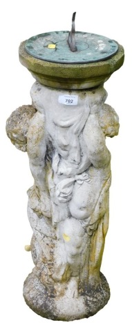 A garden sun dial, the dial top raised on a reconstituted stone base carved as two cherubs, 74cm high.