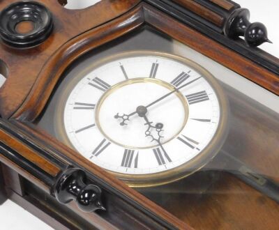 A late 19thC walnut and ebonised cased Vienna wall clock, circular brass dial with enamel chapter ring bearing Roman numerals, single train thirty hour movement, the case with a shaped pediment, and glazed front, with pendulum, weight and key, 110cm high. - 2