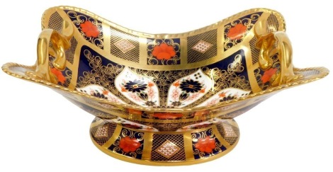 A Royal Crown Derby porcelain two handled dish decorated in the Old Imari pattern, of shaped rectangular form, on circular base, numbered 1128, printed marks, 28.5cm wide.