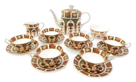 A Royal Crown Derby porcelain tea service decorated in the Old Imari pattern, comprising teapot, 19cm high, six teacups and saucers, milk jug and sugar bowl, numbered 1128, red printed marks.(AF)