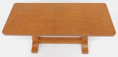 A Robert Mouseman Thompson of Kilburn oak coffee table, the rectangular top raised on two carved columns, one with mouse, on a trestle type base, 43cm high, the top 38cm x 91cm. - 2