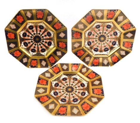 Three Royal Crown Derby octagonal porcelain plates decorated in the Old Imari pattern, gold ground, 1128, red printed marks, 22.5cm wide.