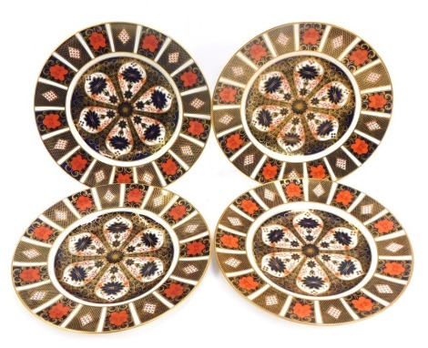 Four Royal Crown Derby porcelain plates decorated in the Old Imari pattern, 1128, red printed marks, 27cm diameter, two on wall mounted plate stands.