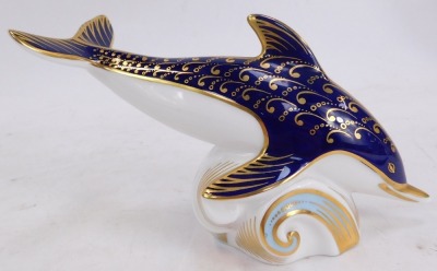 A Royal Crown Derby porcelain paperweight modelled as a dolphin riding a wave, gold stopper and red printed marks, 10cm high. - 2