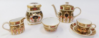 A group of Royal Crown Derby Old Imari pattern porcelain, comprising miniature tea service, teapot, 8cm high (AF), milk jug, teacup and saucer, and sugar bowl, together with a preserve pot and cover, 8cm high, and a pair of salt and pepper shakers, 9.5cm - 4