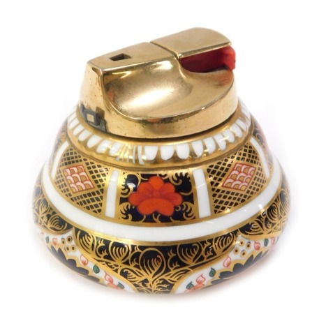 A Royal Crown Derby porcelain table cigarette lighter decorated in the Old Imari pattern, with gilt metal top, 1128, red printed marks, 7cm high.