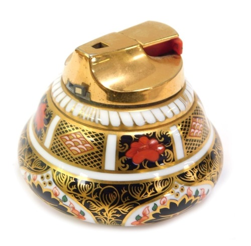 A Royal Crown Derby table cigarette lighter decorated in the Old Imari pattern, with gilt metal top, 1128, red printed marks, 7cm high.