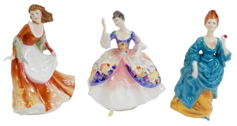 Three Royal Doulton porcelain figures, comprising Christine HN2792, Olga HN2463, and Autumn Time HN3231.