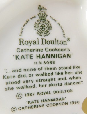 A Royal Doulton porcelain figure, modelled as Katherine Cookson's Kate Hannigan, HN3088, together with Grand Manner HN2723, dated to underside 24th June 1983 and indistinctly signed. (2) - 3