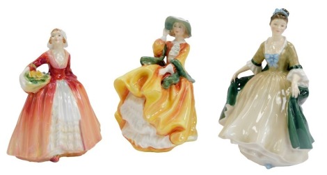 Three Royal Doulton porcelain figures, modelled as Top o' the Hill HN2127, Elegance HN2264, and Janet HN1537.