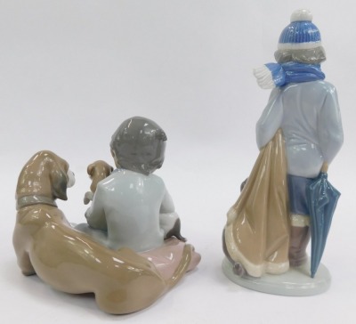 A group of Lladro porcelain figures, comprising boy seated beside dog and puppies, impressed number 5456, 12cm high, boy wearing coat beside a dog, 20cm high, and polar bear, 12cm high. - 3