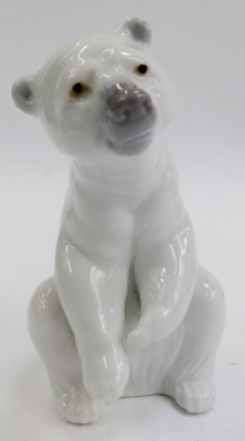 A group of Lladro porcelain figures, comprising boy seated beside dog and puppies, impressed number 5456, 12cm high, boy wearing coat beside a dog, 20cm high, and polar bear, 12cm high. - 4