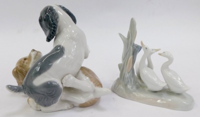 Two pieces of Nao porcelain figures, comprising two dogs playing, 13cm high, and a group of geese beside tree bough, 12cm high, printed marks. - 2