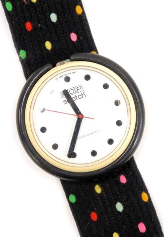 A Pop Swatch watch, the cream watch in a material black and multicoloured spotted strap, the watch head 3.5mm diameter .