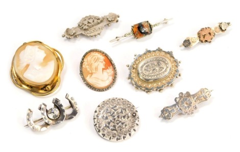 An assortment of Victorian and later brooches, comprising seven silver brooches, some stone set, to include "mother", horseshoes, flower and urns, cameo marcasite and others, 34g all in, and a gilt framed cameo brooch, depicting a maiden with a headdress.