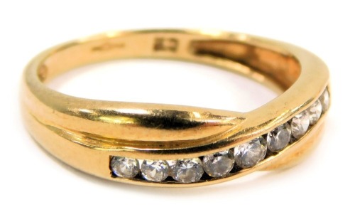 A 9ct gold half hoop dress ring, with tension set tiny diamonds, in a crossover design, with import marks, ring size M½, 1.8g all in.