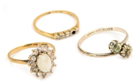 Three dress rings, comprising a 9ct gold imitation opal and diamond cluster ring, an 18ct gold and plat diamond five stone dress ring (one stone missing), and a silver and paste stone set dress ring, 4.1g all in. (AF) (3)