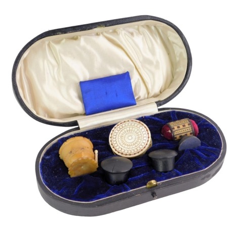 A group of 19thC sewing accoutrements, including mother of pearl lace tape measure, bone thread case, etc, in fitted case.