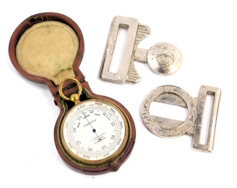 A brass cased pocket barometer, in leather case, and a military steel belt.