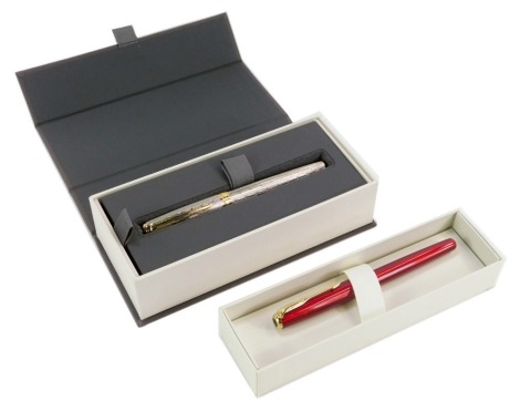 Two cased Parker pens, comprising a Parker Sonnet 11Q fountain pen, with 18ct gold nib, in white gold case with a presentation box, and a Parker red finish fountain pen, boxed. (2)