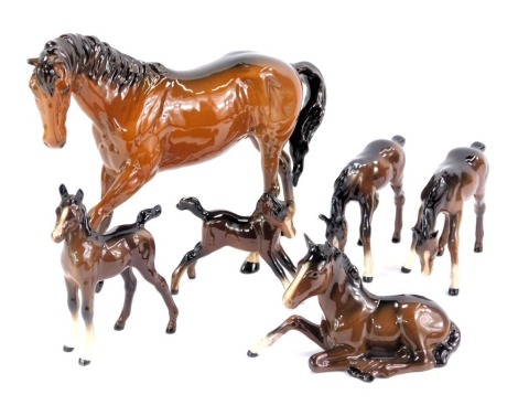 A Beswick pottery model of a horse, in brown, 19cm high, together with five foals, each in differing poses. (6)