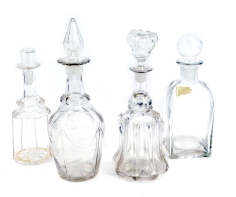 Four 19thC decanters, comprising a square glass decanter with dome top, 26cm high, fluted decanter, 32cm high, and two others, one with star cut base. (4)