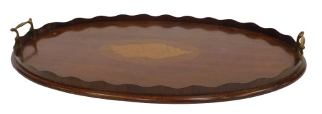 An Edwardian mahogany galleried tray, with twin brass handles, and shell paterae inlay, 70cm x 40cm. (AF)