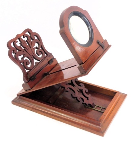 A Victorian mahogany magnifying viewer, with a pierced sliding card holder, raised on a rectangular base, 23cm high, 31cm wide, 20cm deep.